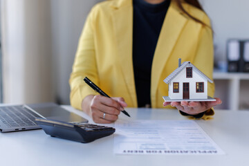 Mortgage Real Estate Broker presenting and advised to model home and building project detail in the office, sign purchase sales contract, agreements concerned mortgage loan offer and insurance.
