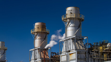 Electricity energy power plant engine and emission at chemical refinery petrochemical industry plant in industrial structure. Technician engineer produce gas gasoline and chemical production business