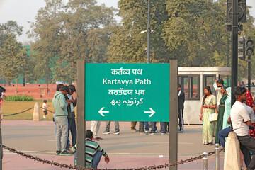 Delhi, India, November 28, 2025: Green directional sign board displaying Kartavya Path written in Hindi English Punjabi and Urdu text with arrows standing on the road for navigation.