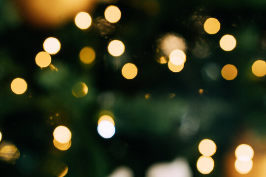 Abstract bokeh lights with green and golden tones in soft focus