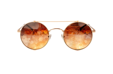 Stylish round sunglasses with gradient lenses and gold frame isolated on black