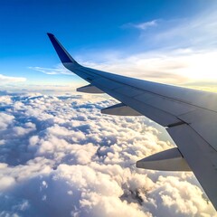 Obraz premium Airplane wing gliding through fluffy clouds under a bright blue sky
