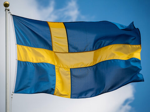 Vibrant Swedish flag waving proudly against a bright blue sky for travel, culture, and national pride concepts and patriotic celebrations
