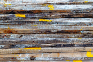 Rustic weathered wooden planks with yellow paint stains