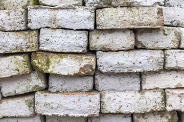 Weathered white bricks with mossy accents in a stacked arrangement