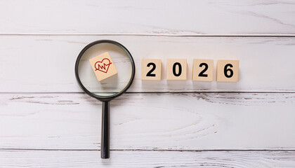 Red Heartbeat Line in Heart Icon Under Magnifying Glass beside 2026 Blocks