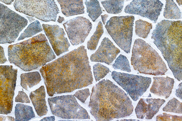 Irregular stone wall with grout in various shades and textures