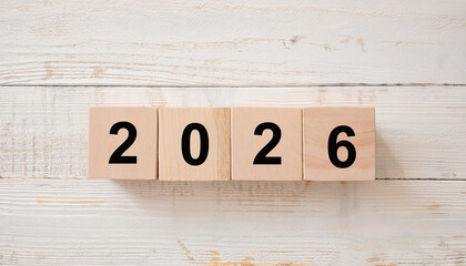 Top View of Wooden Blocks with Black Numbers Arranged Horizontally to Read 2026 on Light Wood