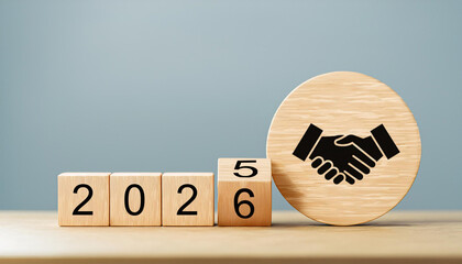 Business Handshake Icon on Wooden Circle with Year Shift from 2025 to 2026 Blocks