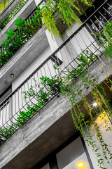 Modern urban building with lush green balconies and vibrant foliage