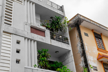 Urban apartment architecture with balcony plants and weathered walls