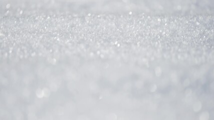 Sunlight glitters across a field of fine snow crystals, revealing intricate icy details in this serene winter macro shot. - Powered by Adobe