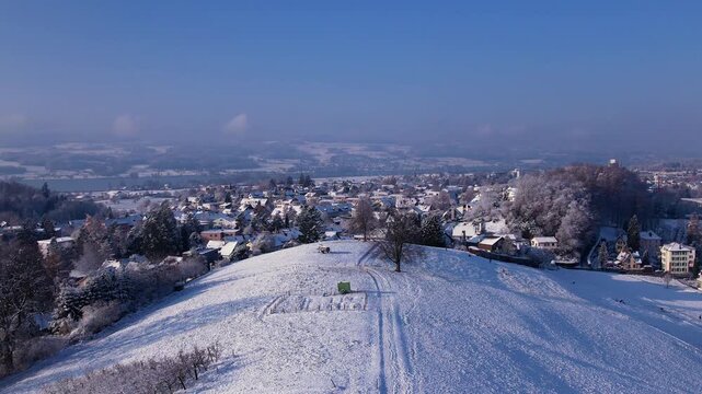 Aerial of a snowy landscape with city in background, Uster, Switzerland
