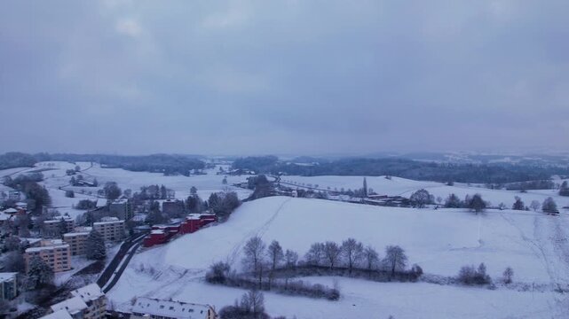 Aerial hyperlapse of a snowy landscape on a cloudy day, Uster, Switzerland