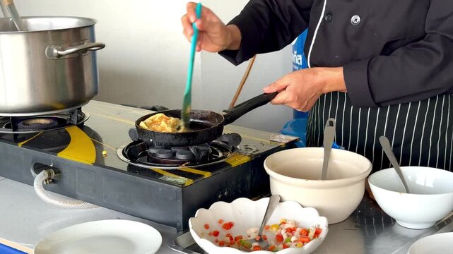 making an omelet with vegetables in a Phuket restaurant for tourists according to the buffet system. High quality 4k footage
