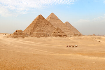 Giza pyramids in Cairo, Egypt. General view of pyramids from the Giza Plateau pyramids known as Queens' Pyramids on front side. Next in order from left, Pyramid of Menkaure, Khafre and Chufu