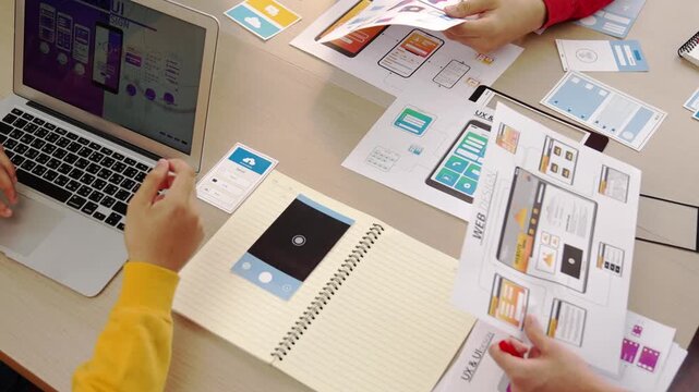 Panorama video of startup company employee planning on user interface prototype for mobile application or website in office. UX UI designer brainstorm designing user friendly interface plan. Synergic