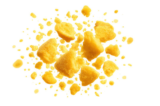 Scattered cheddar cheese crumbs and yellow snack pieces exploding, falling, and floating with a transparent background