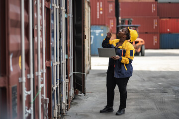 African woman logistics workers use notebook computer checking container	