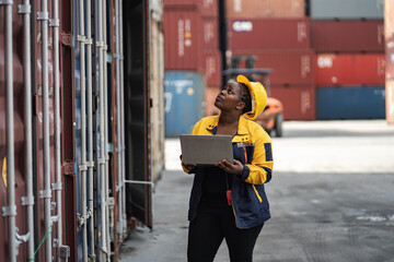 African woman logistics workers use notebook computer checking container	