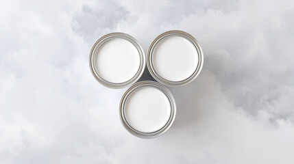 2026 color trend. Top view of three open cans of white paint arranged in a triangular formation on a soft white background, showcasing a clean and minimalistic aesthetic with copy space