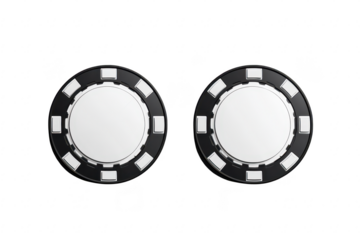 Two identical black and white poker chips resting on a clean. white surface. their circular shape and design. ideal for use in gaming or casino-related materials
