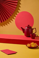 A simple New Year still life with a red circular panel, a red cup, and small festive items. Clean and minimal, perfect for product mockups or banner layouts.