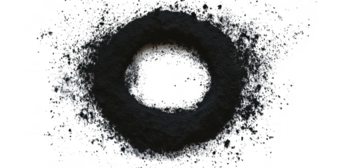 A circular arrangement of black powder on a white surface. creating a striking contrast. possibly used for artistic or decorative purposes. with a clean. minimalist background