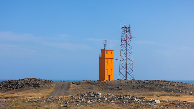 Hvalnes Lighthouse and communication tower on a east coast of Iceland clear sunny day