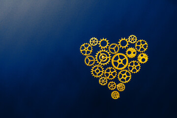 Innovation and creativity with golden gear heart on dark blue background, copy space.