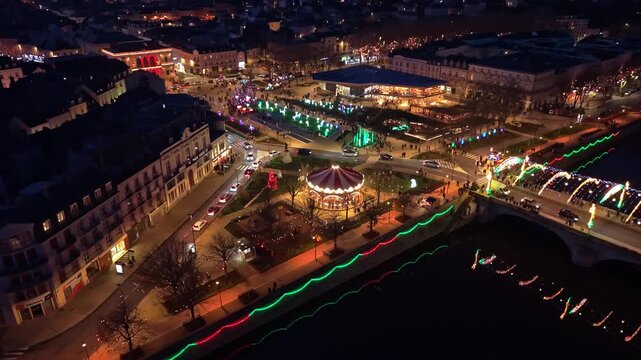 Panning drone fly over November 11th Square and Aristide-Briand Bridge with beautifully illuminated Christmas environment, Laval, Mayenne, France
