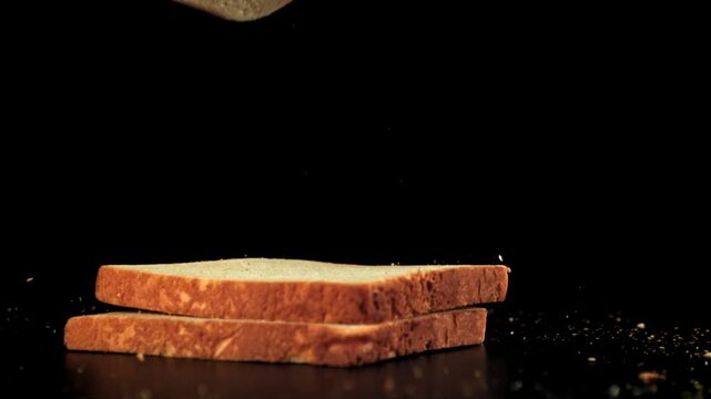Pieces of bread fall on the table. Filmed on a high-speed camera at 1000 fps. High quality FullHD footage