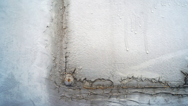 Abstract texture of old weathered building wall with peeling paint