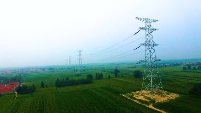 High Voltage Power Transmission Tower in Agricultural Landscape