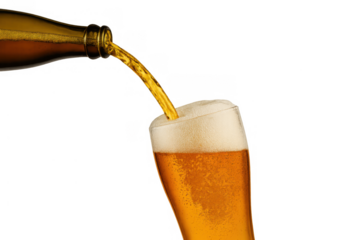 Golden beer pouring from a bottle into a pilsner glass, creating a rich head of foam, on a transparent background