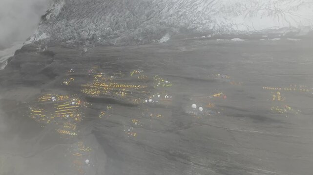 Drone footage showcases Manaslu Base Camp below the 8,163m Himalayan peak. The scene reveals snowy ridges, rugged terrain, and the dramatic high-altitude environment of this remote mountain region.
