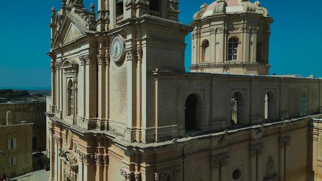 Exterior of St. Paul's Cathedral, Mdina, Malta, close-up ascending aerial view