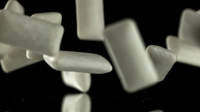 Chewing gum falls on the table. Filmed on a high-speed camera at 1000 fps. High quality FullHD footage