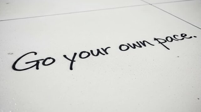 Inspirational message on tile flooring encouraging selfpaced progression