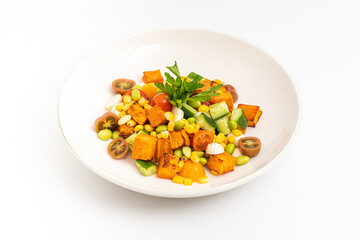 Roasted sweet potato salad mixed with corn, cucumber and herbs