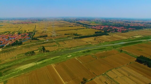 High Voltage Tower Over Agricultural Landscape - Aerial View