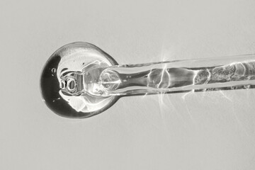 Cosmetic gel or serum on a gray background. Color of the Year 2026, Cloud Dancer.