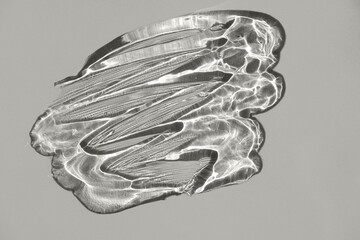 Transparent cream gel texture with bubbles on a gray background. Color of the Year 2026, Cloud Dancer.