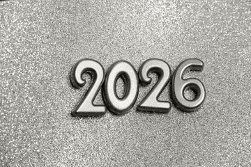 Golden numbers 2026 on a sparkling background. New Year's celebration concept. Color of the Year 2026, Cloud Dancer.