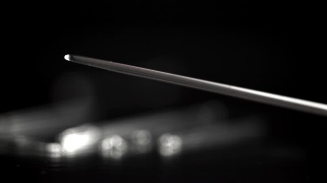 A sewing needle falls on the table. Filmed on a high-speed camera at 1000 fps. High quality FullHD footage