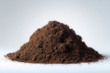 Close up of a pile of peat moss substrate on white surface