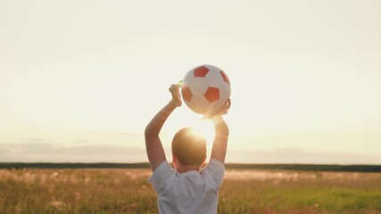 boy jumping up nature, child kid sunset, child victory, feeling victory, people ball, hands raised up sunny sky victory, silhouette of young footballer with ball overhead, boy holding soccer ball at - Powered by Adobe