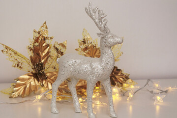 Reindeer and Christmas decorations, minimalist decoration on a shelf at home
