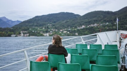 Fototapeta premium Ferry deck with shallow blurred focus, defocused lake and hazy mountain vista, outdoor; backdrop copyspace backplate.