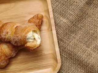 cream horn bread pastries on wooden board. Top view with Copy space